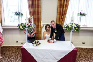 bride and groom signing the register